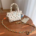Detaillierte Stepptextur der geblümten Baumwolltasche mit buntem Web-Schultergurt - Blumenbär
