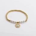 Golden beaded stretch bracelet with white pearls and a detailed Evil Eye charm pendant - Gold Beaded Evil Eye