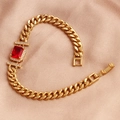Close-up of a gold-plated bracelet with a red rectangular zircon on rose gold silk fabric - Red Zirconia