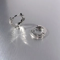 Close-up of silver huggie earrings with double row paved zirconia on metal background - Double Row Pave / White Gold