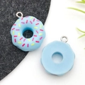 Light blue resin donut pendant with colorful sprinkles and metal hanging loop - Blue Donut