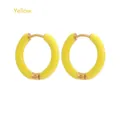 Close-up of 12mm yellow enamel hoop earrings with polished stainless steel finish - Yellow