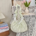 Detail of mint green floral lace bag with white embroidery hanging on a vintage wooden chair - Chiffon Petal Green