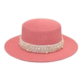 Pink woven flat top straw hat with elegant pearl embellishments for summer beach wear - Pink