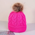Detail of rose red cable knit winter beanie with a large faux fur pompom on top - One Size / Rose Red