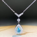 Detailed macro shot of a blue pear-cut crystal pendant with V-shaped silver bail - 925 Silver / Blue Zirconia-XL103