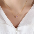 Elegant gold necklace with rectangular purple zircon pendant worn on a model - Light Purple/June
