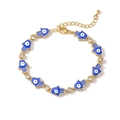 Golden Hamsa hand bracelet with blue enamel eye charms and sparkling rhinestones - Sapphire Blue