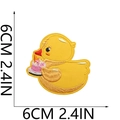 Close-up of yellow duck embroidery patch with cake showing 6cm 2.4in size detail - Celebration Duck with Cake