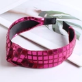 Detail of rose red knotted headband with sequin checkered pattern on a magazine - Rose Red
