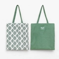 Detail of two-sided canvas tote bags featuring leaf print and Life With Leaves fabric label - White Base Small Leaf
