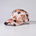 Detail of silk-texture baseball cap with artistic multi-color polka dots on light pink - Wave Point Khaki