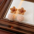 Macro view of flocking flower earrings with pompon pendant and pearl details - Coffee Flower with Apricot Pom Pom (Large)