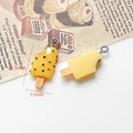 Macro detail of 21.5mm yellow popsicle charm with dimensions on vintage paper background - Yellow Ice Cream