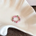 Detailed view of pink and green floral glass beaded stretch ring on a shell tray - Handcrafted Floral Pattern Colorful Beaded Ring / 74# Colorful-Beads
