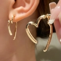 Minimalist gold heart-shaped hoop earring with high-gloss metallic finish and sleek curves - Open Heart Style (K-599) / 44 KC Gold
