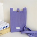 Detailed texture of lavender purple knit mobile phone bag with silver button and white label - Eggplant Purple
