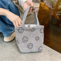 Close-up of gray corduroy tote bag with embroidered smiles and metal snap button - Gray Smiley Face
