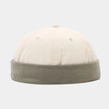 Detail of two-tone cotton docker hat featuring olive green brim and cream white top - Beige With Green Edge