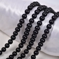 Polished multi-strand black glass pearl beads jewelry on white satin fabric background - 6mm Straight Hole/Approx 65pcs Per Strand / Agate Black