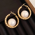 Close-up of gold textured hoop earrings featuring large white pearls on black velvet background - Gold-Beige (Real Gold Plated / S925 Silver Pin)