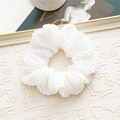 Detailed view of a white pleated organza scrunchie with elegant ruffled fabric texture - Accordion Pleated / White
