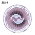 Self-adhesive reusable black eyelashes ZD05 in a clear round case on pink glitter - ZD05