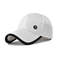 Detalle de gorra blanca con visera negra e insignia metálica de la letra M - Blanco