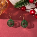 Close-up of green wire-wrapped ball earrings with red beads on a festive background - D1298 (Spring Ball Ring)