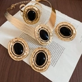 Close-up of vintage hammered gold jewelry set with black oval acrylic stones - Set - Gold - Black (4-piece Set)