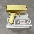 Golden electric money gun detail with props banknotes on packaging box setup - Painted Gold / Painted Gold Money Gun + 100 Notes