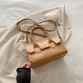 Chic khaki PU leather handbag with top handle and shoulder strap on beige blazer - Khaki