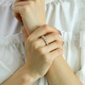 Close-up of elegant 18K gold plated ring with seven sparkling round zircon stones - US 7 / Gold White Zirconia