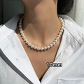 Close-up of 10mm cream pearl pendant on a gold necklace with natural light shadow - 33# Gold White 10mm Pearl Necklace
