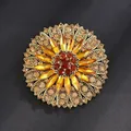Vintage gold sunflower brooch with amber crystal petals on a dark textured surface - Antique Gold, Coffee Yellow Sunflower