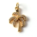 Macro shot of a gold-plated coconut tree pendant with sparkling clear cubic zirconia - Coconut Tree with Zircon