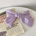 Elegant purple satin butterfly hair claw clip with glossy silk texture on newspaper - Purple Satin Bow Spring Clip / Purple