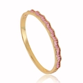 18k gold plated wave bangle with pink zircon stones on a white background with reflection - Pink