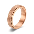 Detail of rose gold 6mm spinner ring featuring sparkling sand finish and brushed metal - 6mm Rose Gold Spinner Ring