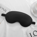 Silky black sleep mask with elastic strap on a white background for travel comfort - Black