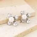 Detailed macro view of silver flower earrings featuring white pearls on a stone base - Silver Flat Petal With Pearl (KE114181-KFC)