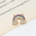 Macro shot of gold-plated rainbow pendant with multicolored stones on vintage book page - 3# Double-Hanging Rainbow