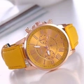 Close-up of Geneva gold-tone dial with Roman numerals and bright yellow leather strap - Yellow