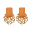 Detail view of retro geometric wooden earrings with orange blocks and beige woven beads - Style 12