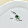 Detailed macro view of silver daisy pendant with green pear-shaped zircon, 25mm length - Silver-Green Zircon