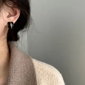 Minimalist vintage black and gold thickened hoop earrings on model with knit sweater - Ear Clip (Non-Pierced) / Classic Black