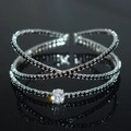 Macro view of luxurious silver bangle with crisscross design and black zircon stones - Silver Black Zirconia