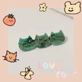 Detail of green marble acetate hair clip with three cat heads and golden whiskers - Starry Dark Green Cat