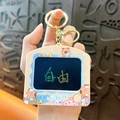 Cute cartoon TV-shaped Capybara keychain with golden ring and lobster clasp accessory - Writing Board - Coffee