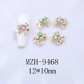 Detail of 12x10mm gold bow nail charm with heart crystal and size specifications - Gold Base Pink with Green Heart (9468)